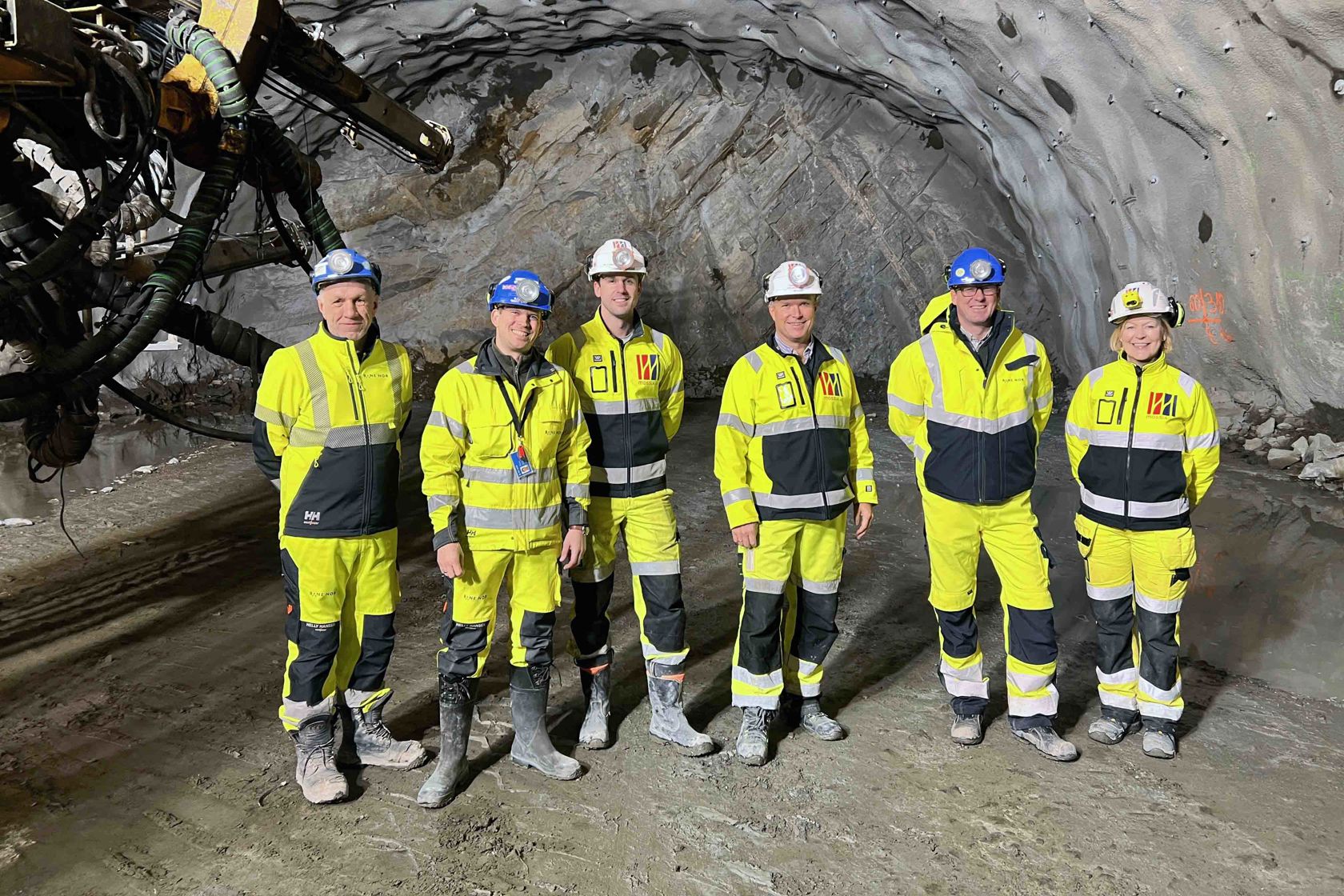 Flere menn i vernetøy står foran tunnelendevegg