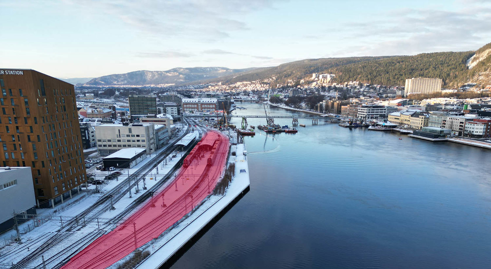 Oversiktsbilde over Drammenselva , stasjonen og deler av byen. 