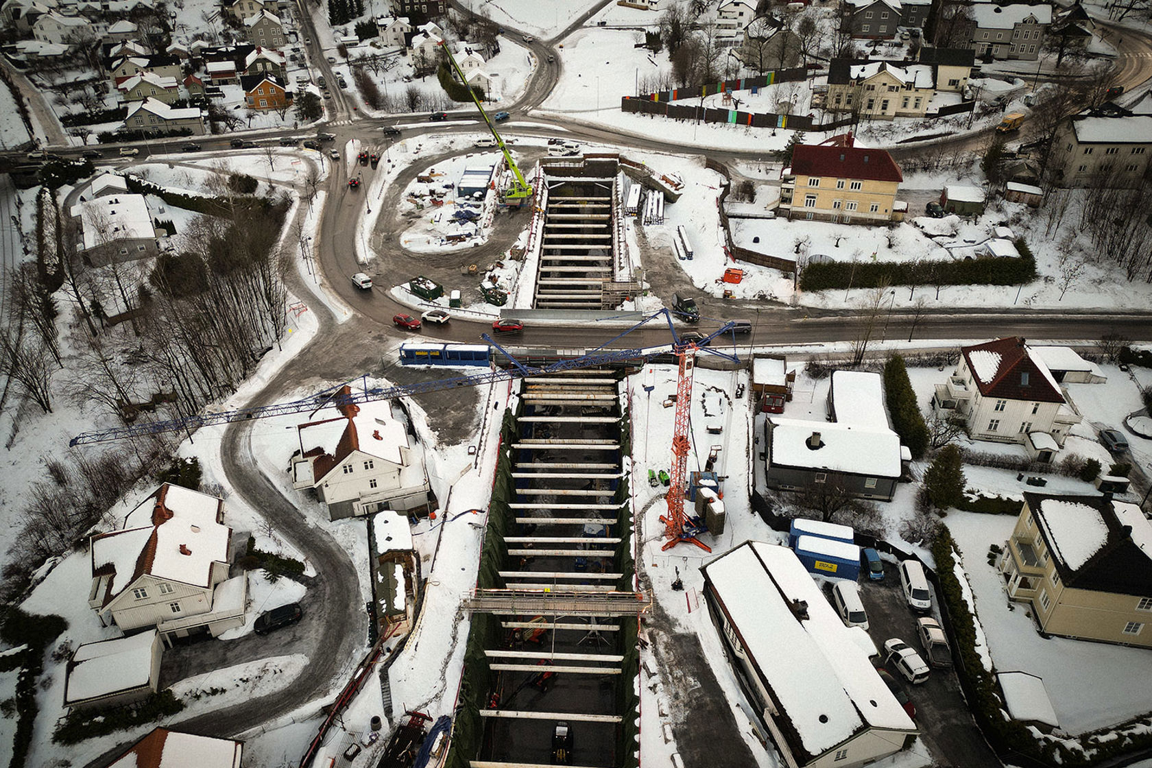 Dronefoto av byggegrop som viser omkringliggende boligområde. 